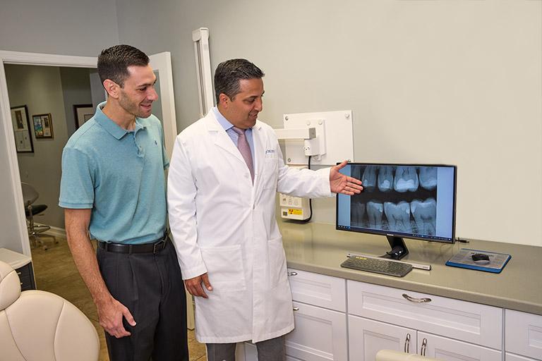 Dr. Alegre showing a patient X-rays.