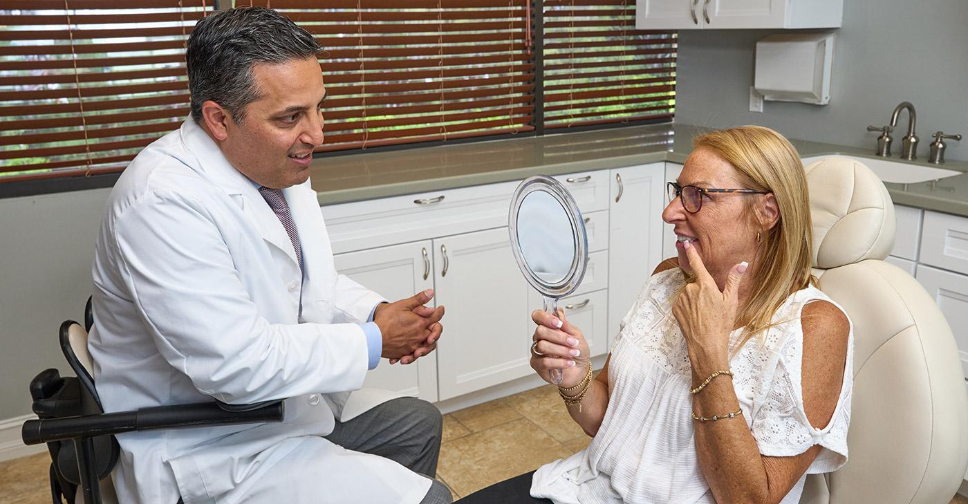 Dr. Alegre consulting with a patient about full-mouth rehabilitation treatment.