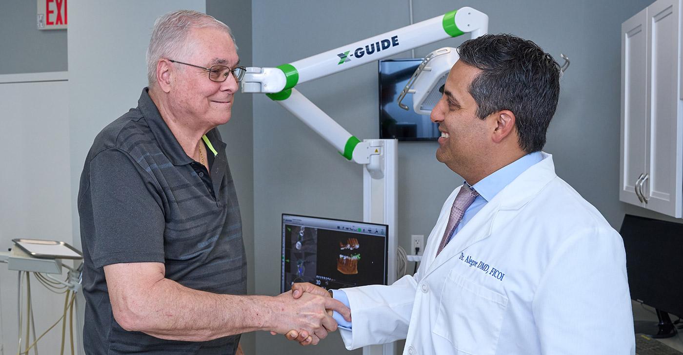 Dr. Alegre shaking hands with a patient.
