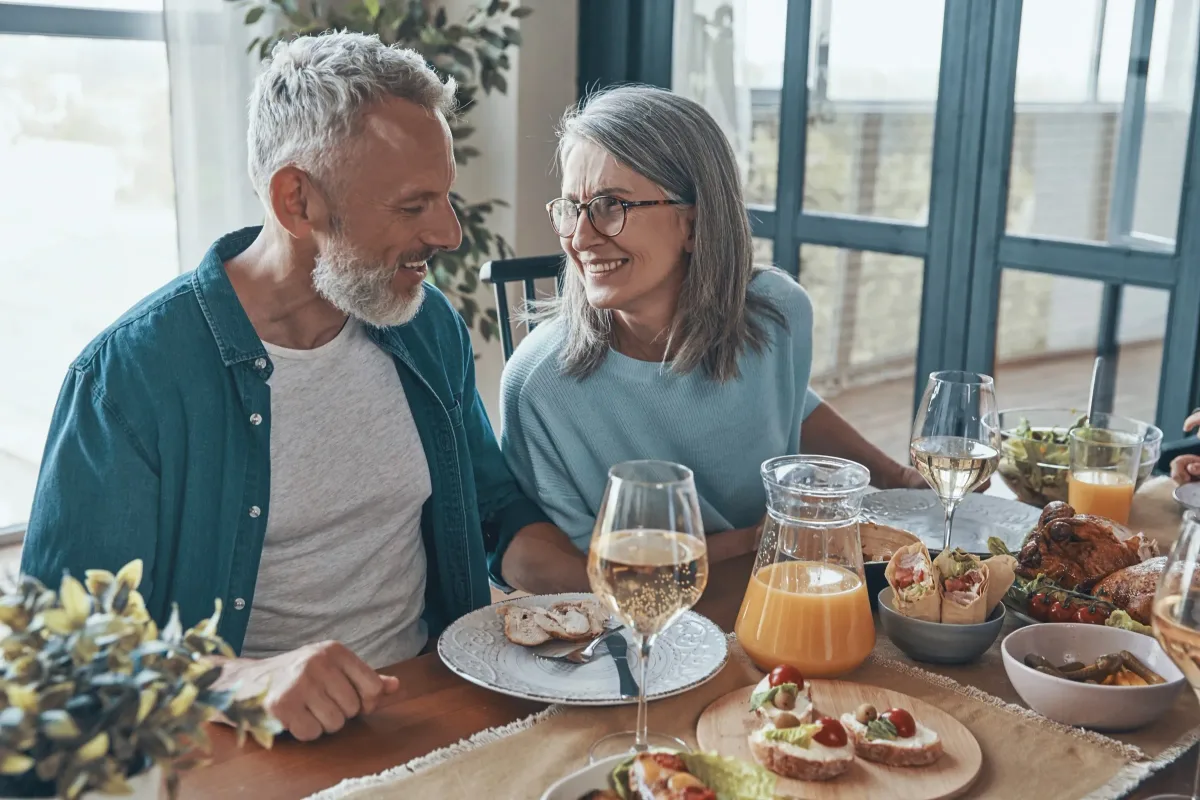Older couple enjoying a meal together at a table