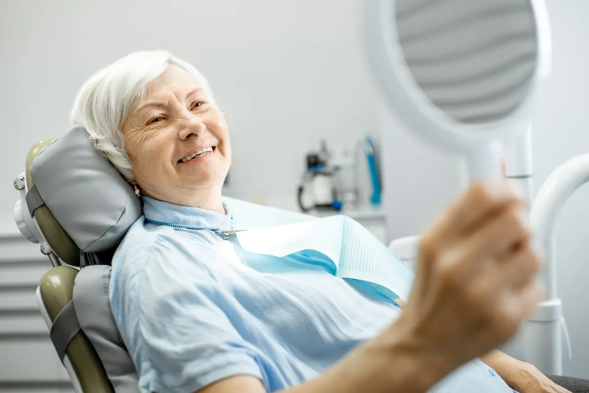 Older woman sitting comfortably in a dental chair during a consultation